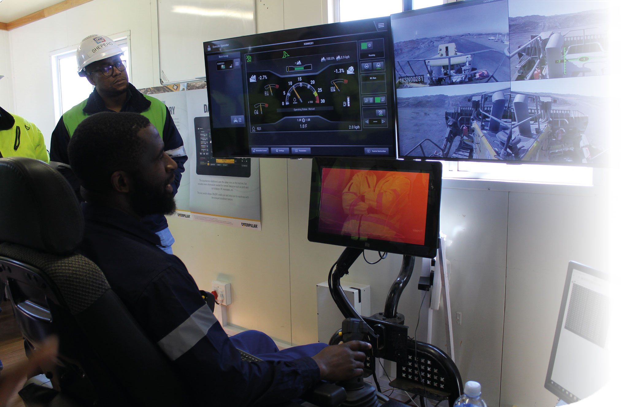 Automated dozing in action at Mafube. From the left: Sheperd Nkadimeng (general manager), Mogodi Mahapa (mining manager) and seated Ernest Sibanyoni
(training officer)